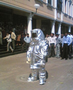 A man in a space suit, surrounded by a contemporary crowd.  Photo by Vivek Patankar.
